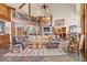 Spacious living room with high ceilings, a stone fireplace, and leather furniture at 28940 Pinewood Vista Dr, Evergreen, CO 80439