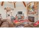 Cozy living room with a stone fireplace and views to the dining room at 28940 Pinewood Vista Dr, Evergreen, CO 80439