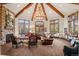 Vaulted ceiling living room with a stone fireplace and ample seating at 28940 Pinewood Vista Dr, Evergreen, CO 80439