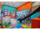 Playroom with climbing wall, slide, and colorful decor at 28940 Pinewood Vista Dr, Evergreen, CO 80439