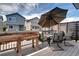Outdoor dining area with seating and a large umbrella on a wooden deck at 4100 Albion St # 1509, Denver, CO 80216