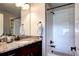 Modern bathroom with granite countertops, dark wood cabinets, and a shower and tub combination at 4100 Albion St # 1509, Denver, CO 80216