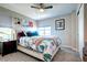 Cozy bedroom with a floral patterned bed, soft colors, a ceiling fan, and ample natural light at 4100 Albion St # 1509, Denver, CO 80216