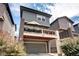Two-story house with a large deck above the garage, featuring outdoor seating, and modern design at 4100 Albion St # 1509, Denver, CO 80216