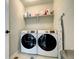 Functional laundry room equipped with modern washer and dryer units and storage shelving at 4100 Albion St # 1509, Denver, CO 80216