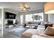 Comfortable living room featuring a large sectional, fireplace, and abundant natural light at 4100 Albion St # 1509, Denver, CO 80216