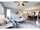 Living room featuring a large sectional sofa that flows into the dining area and kitchen at 4100 Albion St # 1509, Denver, CO 80216