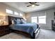 A well-lit primary bedroom features a large bed with blue bedding and coordinated bedside tables at 4100 Albion St # 1509, Denver, CO 80216
