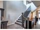 Carpeted stairwell with dark wood railing leading to the upper level at 4100 Albion St # 1509, Denver, CO 80216