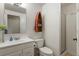 Bright bathroom featuring a toilet, a shower with glass door, sink, and a boat-shaped shelf at 1503 W Briarwood Ave, Littleton, CO 80120