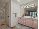 Bright bathroom with double sinks, ample counter space, and a large mirror reflecting the bedroom at 1503 W Briarwood Ave, Littleton, CO 80120