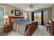 Well-lit bedroom featuring a wooden bed frame, balcony access, and serene outdoor views at 1503 W Briarwood Ave, Littleton, CO 80120