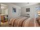 Relaxing bedroom with neutral tones, en-suite bathroom access, and a view of the vanity at 1503 W Briarwood Ave, Littleton, CO 80120