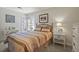 Stylish bedroom with a metal bed frame, coordinated decor, and a corner window providing natural light at 1503 W Briarwood Ave, Littleton, CO 80120