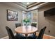 Cozy dining area features a round table, four chairs, and a bright window at 1503 W Briarwood Ave, Littleton, CO 80120