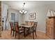 Formal dining room with a glass table, wood chairs, and a decorative chandelier at 1503 W Briarwood Ave, Littleton, CO 80120