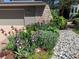 Charming home exterior with stone accents, tidy flower garden, and well-maintained landscaping at 1503 W Briarwood Ave, Littleton, CO 80120
