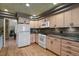 Well-equipped kitchen with ample counter space, light wood cabinets, and modern appliances at 1503 W Briarwood Ave, Littleton, CO 80120