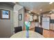 Open kitchen area with views of the dining table, kitchen appliances, and cabinetry at 1503 W Briarwood Ave, Littleton, CO 80120