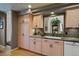 Kitchen showcasing light wood cabinetry, granite countertops, and an undermount sink at 1503 W Briarwood Ave, Littleton, CO 80120