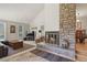 Cozy living room with stone fireplace and natural light at 1503 W Briarwood Ave, Littleton, CO 80120