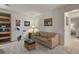 Inviting living room with comfortable seating, exercise bike, and hardwood book shelves at 1503 W Briarwood Ave, Littleton, CO 80120