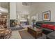 Spacious living room featuring fireplace, bench seating, and a comfortable sofa at 1503 W Briarwood Ave, Littleton, CO 80120