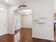 Open-concept view of a dining room featuring hardwood floors, natural lighting, and an elegant chandelier at 19368 E Quincy Pl, Aurora, CO 80015