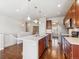 Well-lit kitchen featuring stainless steel appliances, hardwood floors, and an open layout connecting to other areas at 19368 E Quincy Pl, Aurora, CO 80015