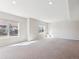 Spacious living room with natural light, windows overlooking a yard, and neutral carpet at 19368 E Quincy Pl, Aurora, CO 80015