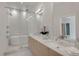 Well-lit bathroom with walk-in shower, soaking tub, double sinks, and stylish fixtures at 2314 S University Blvd, Denver, CO 80210