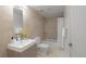 Modern bathroom with neutral-tiled shower and bath, sleek fixtures and bright lighting at 2314 S University Blvd, Denver, CO 80210
