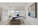 Bright bedroom featuring neutral colors, three windows, carpeted floors, and modern decor at 2314 S University Blvd, Denver, CO 80210