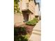 Inviting entrance with landscaped garden, showcasing charming brickwork and manicured greenery at 2314 S University Blvd, Denver, CO 80210