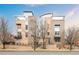 Modern multi-story home with brick and light-colored siding, metal roof, and small balconies at 2314 S University Blvd, Denver, CO 80210