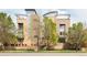 Contemporary building with a sleek design, offering balconies and modern architectural details and mature trees at 2314 S University Blvd, Denver, CO 80210