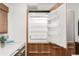 Built-in refrigerator with wood cabinetry with pull out drawers; counter top is light grey at 2314 S University Blvd, Denver, CO 80210
