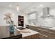 Contemporary kitchen with stainless steel range hood, a large island, and modern white cabinetry at 2314 S University Blvd, Denver, CO 80210