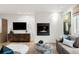 Bright living room with a modern fireplace, stylish furnishings, and hardwood floors at 2314 S University Blvd, Denver, CO 80210