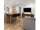 Open-concept space connecting a kitchen island and living area, complemented by hardwood floors at 2314 S University Blvd, Denver, CO 80210