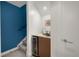 Basement wet bar with wine fridge, sink, and storage at 2314 S University Blvd, Denver, CO 80210