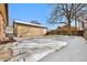 Large backyard with snow covered grass and detached garage at 1070 W Oxford Ave, Englewood, CO 80110