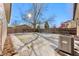 Backyard with a snow-covered lawn and tree at 1070 W Oxford Ave, Englewood, CO 80110