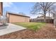Backyard with detached garage and landscaped lawn at 1070 W Oxford Ave, Englewood, CO 80110