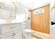 Modern bathroom with a white vanity and gold fixtures at 1070 W Oxford Ave, Englewood, CO 80110