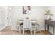 Small dining area with a simple table and two chairs, adjacent to hallway at 1070 W Oxford Ave, Englewood, CO 80110