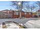 Brick ranch house with a snow-covered yard at 1070 W Oxford Ave, Englewood, CO 80110
