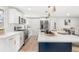 Bright kitchen featuring white cabinets, an island with a navy base, and stainless steel appliances at 1070 W Oxford Ave, Englewood, CO 80110