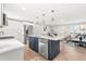 Modern kitchen with white cabinets, a large island, and stainless steel appliances at 1070 W Oxford Ave, Englewood, CO 80110