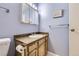 Cozy bathroom featuring vanity with tan countertops and wood cabinets and a mirrored medicine cabinet at 3663 S Sheridan Blvd # 14, Denver, CO 80235